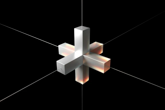 A white three-dimensional cross suspended by thin wires against a black background